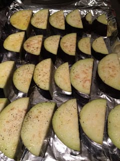 Eggplants cut, oiled, and salted before going into the oven.