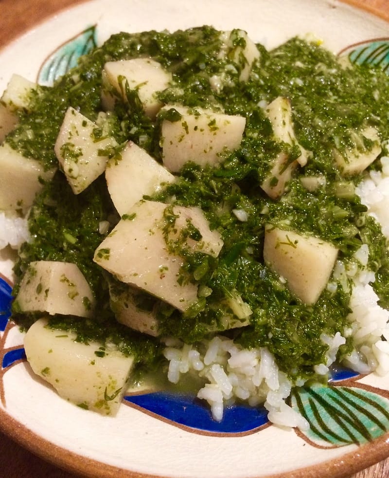 Chunks of cooked taro, minced fresh herbs and swiss chard with rice.